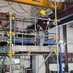 NC Contractor worker on scaffolding wearing full body harness at Tuas facility — workplace safety in action